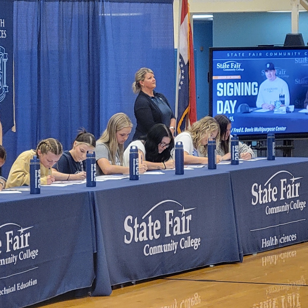 Several student signing at State Fair Community College.