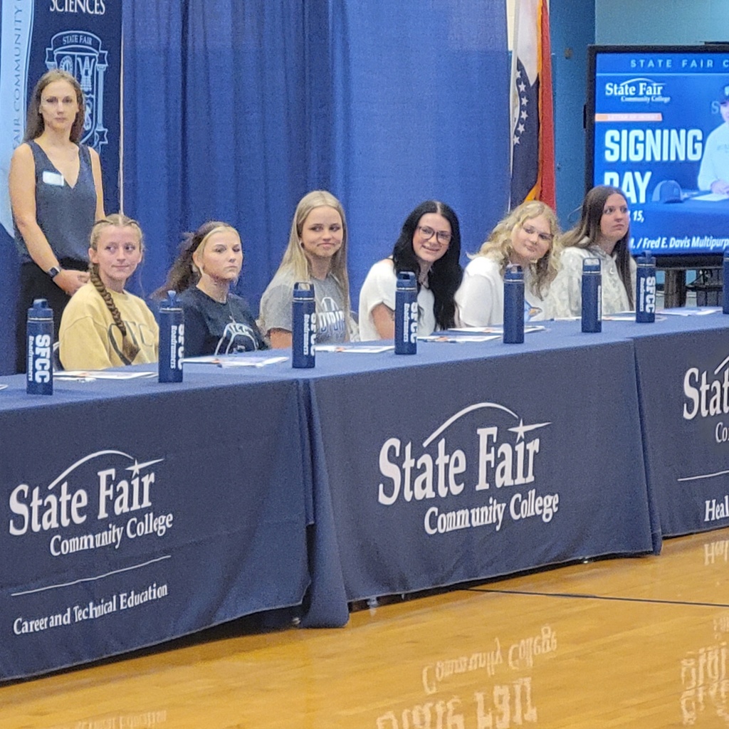 Several senior girls posing at the college signing day.