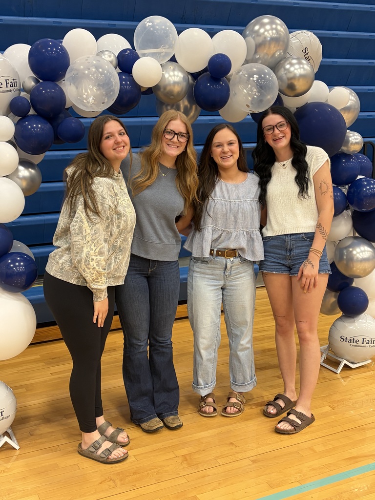 Four senior girls posing at the college signing day.