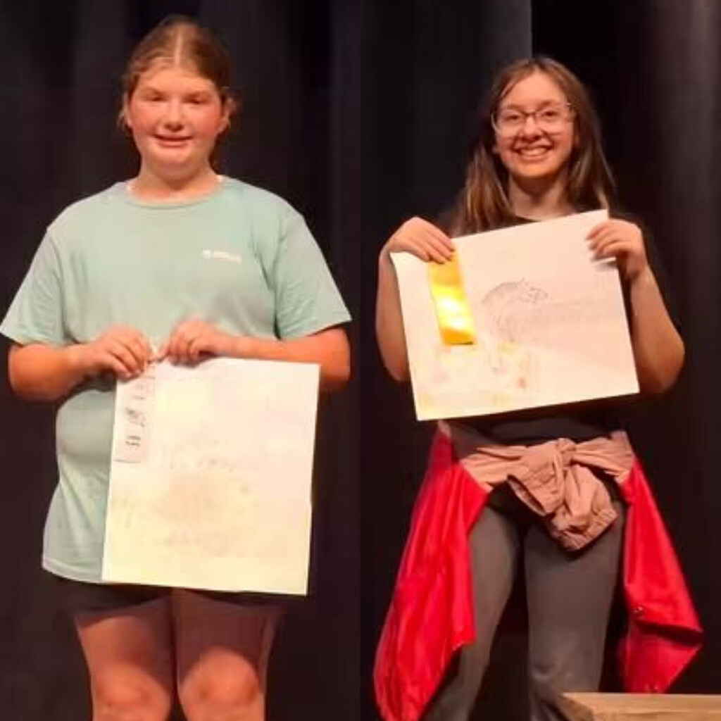 6th grader Lexi White and 8th grader Tilly Ahlers receive ribbons for their artwork in colored pencil. Lexi got a 3rd place and Tilly got a 4th place.