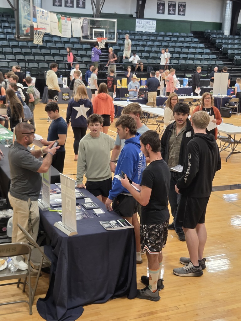 Lots of high school students in the gymnasium filled with booths of college representatives.