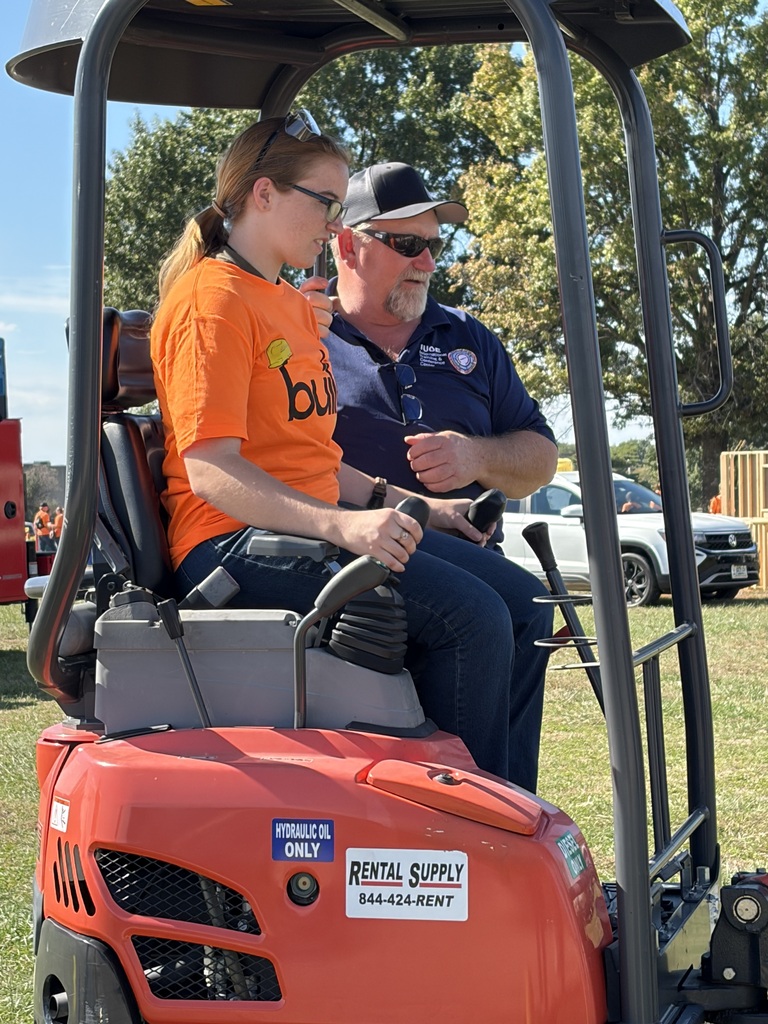 High School student and instructor teaching student how to operate a front loader