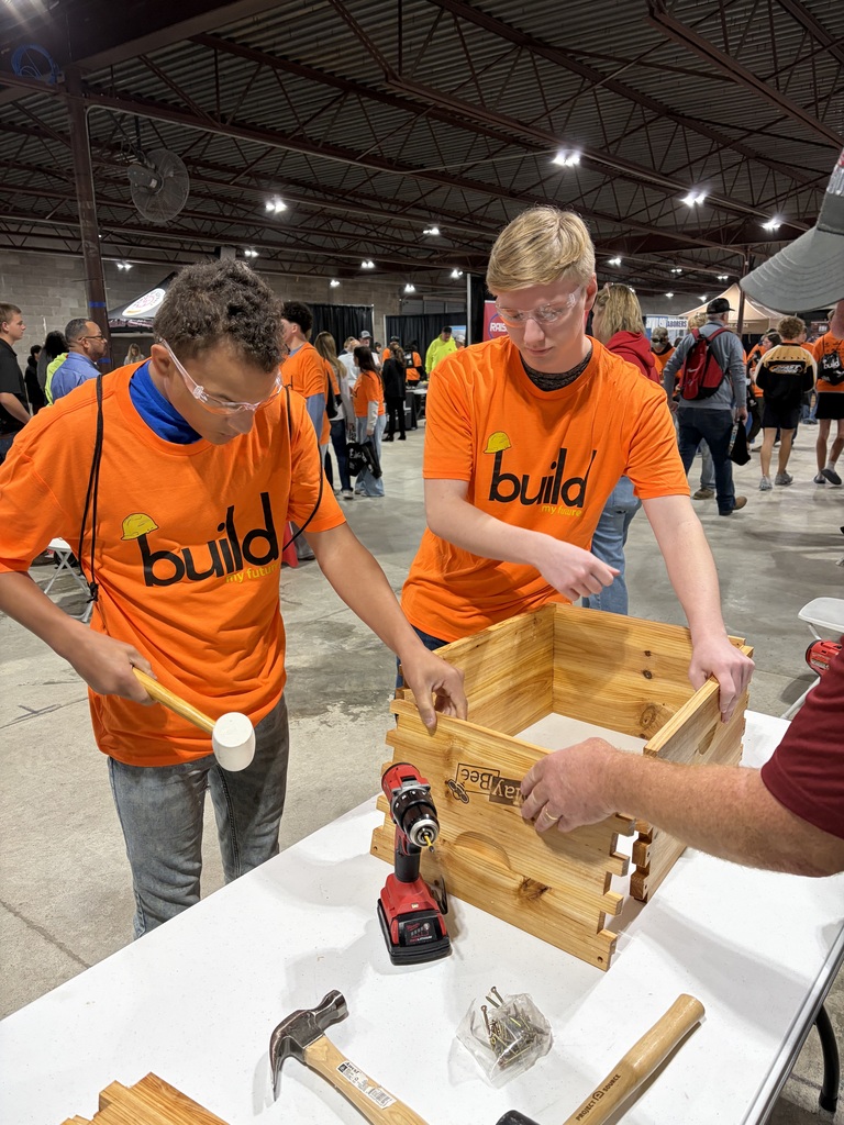 Two high school students building a wooden bee box at Build My Future 