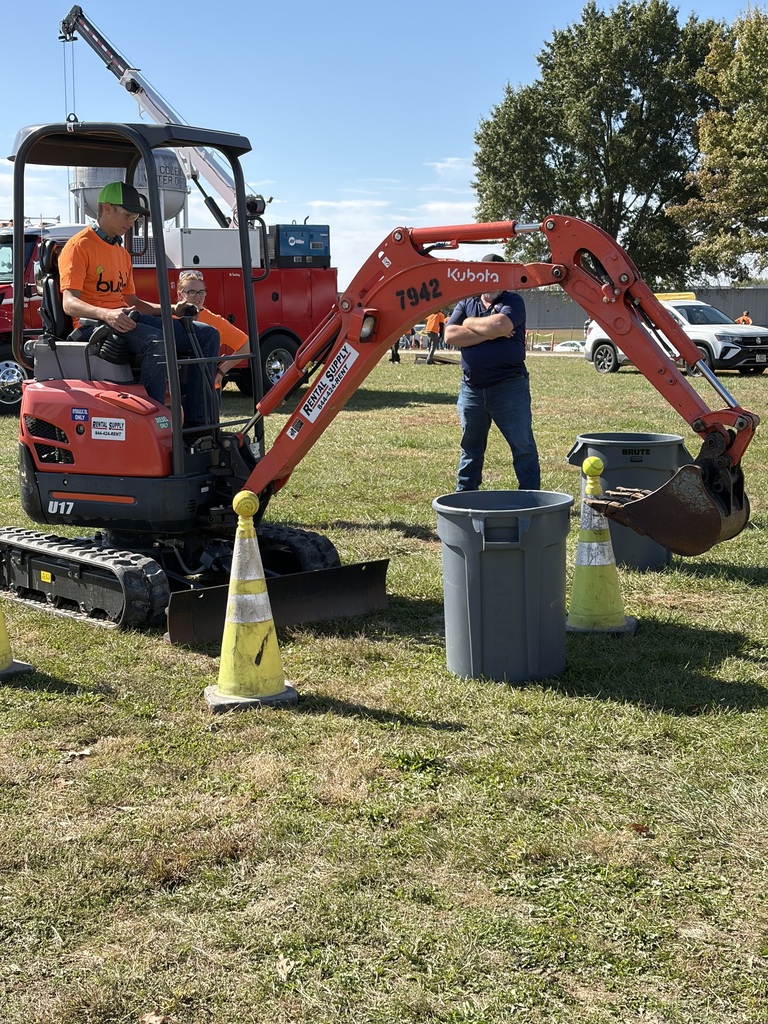 High School student operating a front loader with instructor supervising at Build My Future