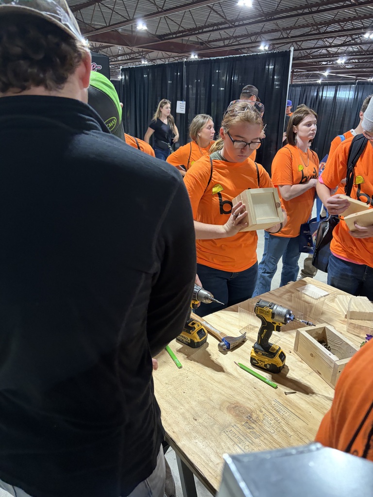 High school students standing around a work bench  building a flower box at Build My Future