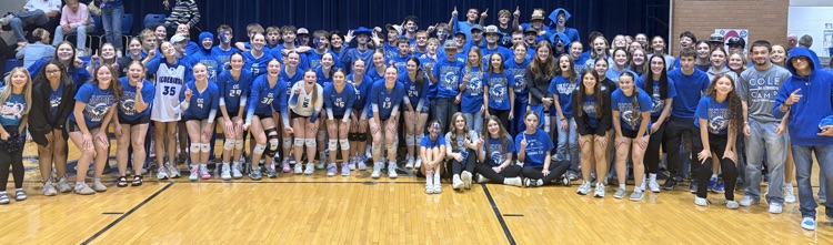 Volleyball players and the student section pose after the Lady Bluebirds beat Miller