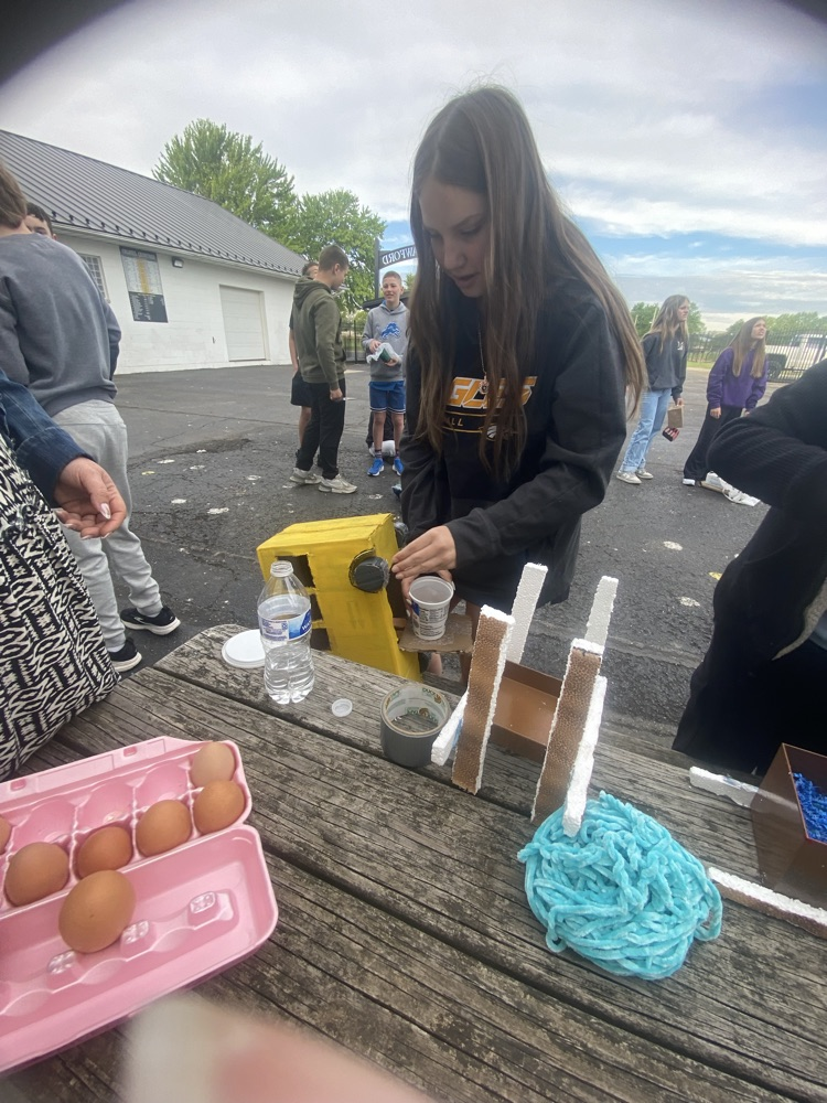 kid and eggs at a table building