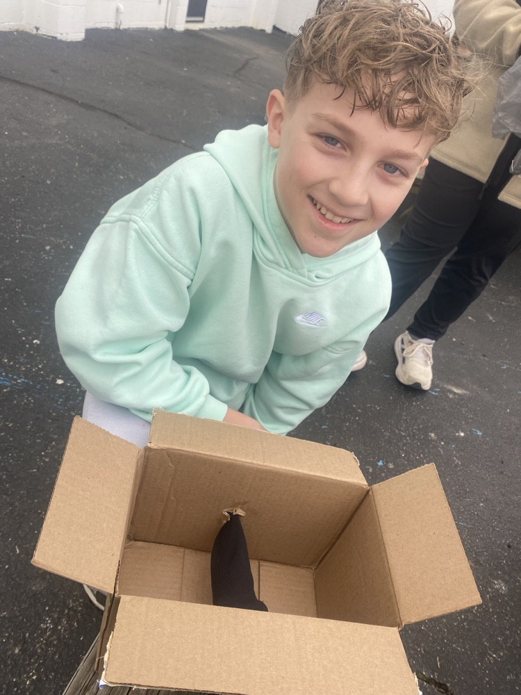 A student with a cardboard box