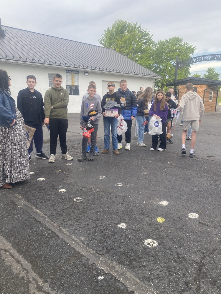 A group of students standing with their projects
