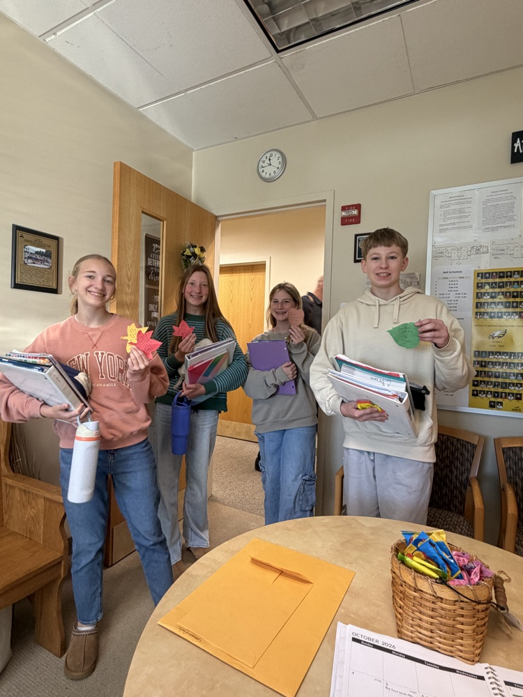 several students with notes from teachers