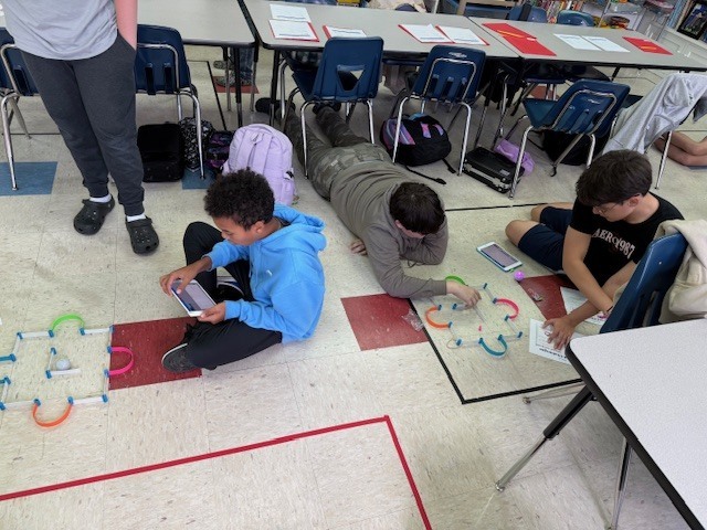 Middle school students with robots