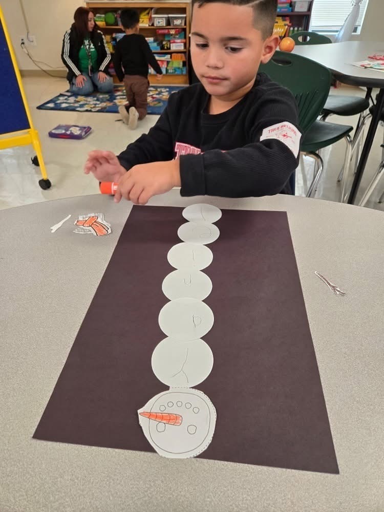 Boy Building Name Snowman