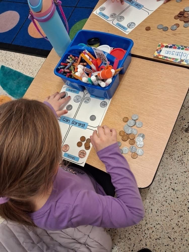 Student sorting money
