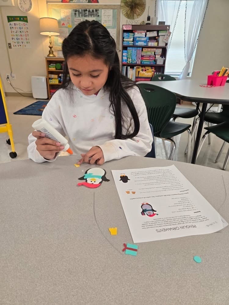 Girl working on penguin ornament activity
