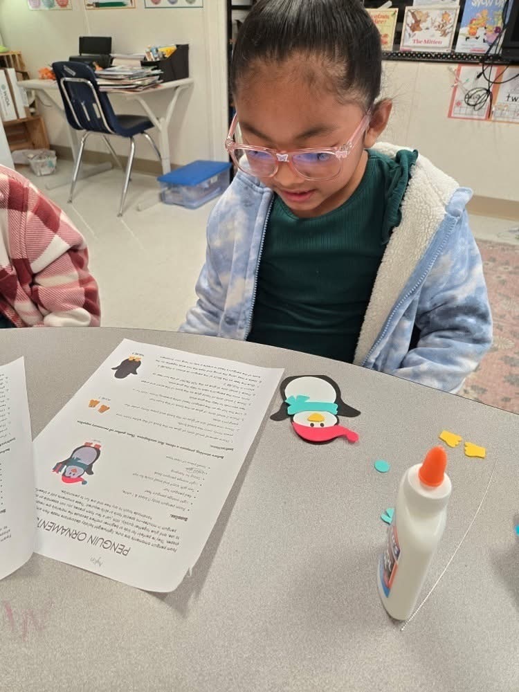 Girl working on penguin snow activity in class