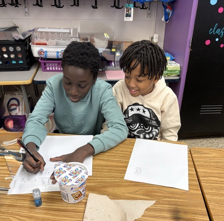 Boys collaborating on Math Worksheet