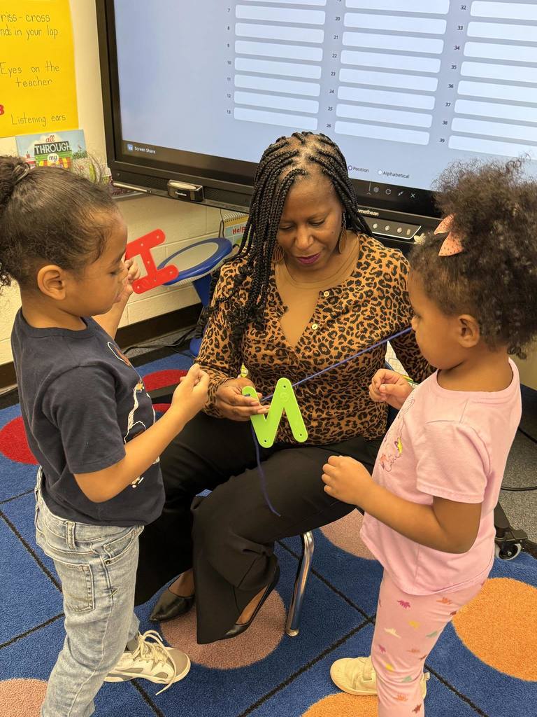 Teacher helping students