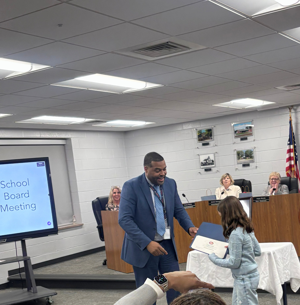 Superintendent Handing Student an Award