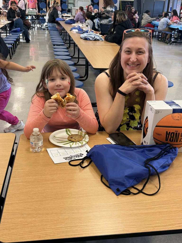 Girl and Mom eating pizza