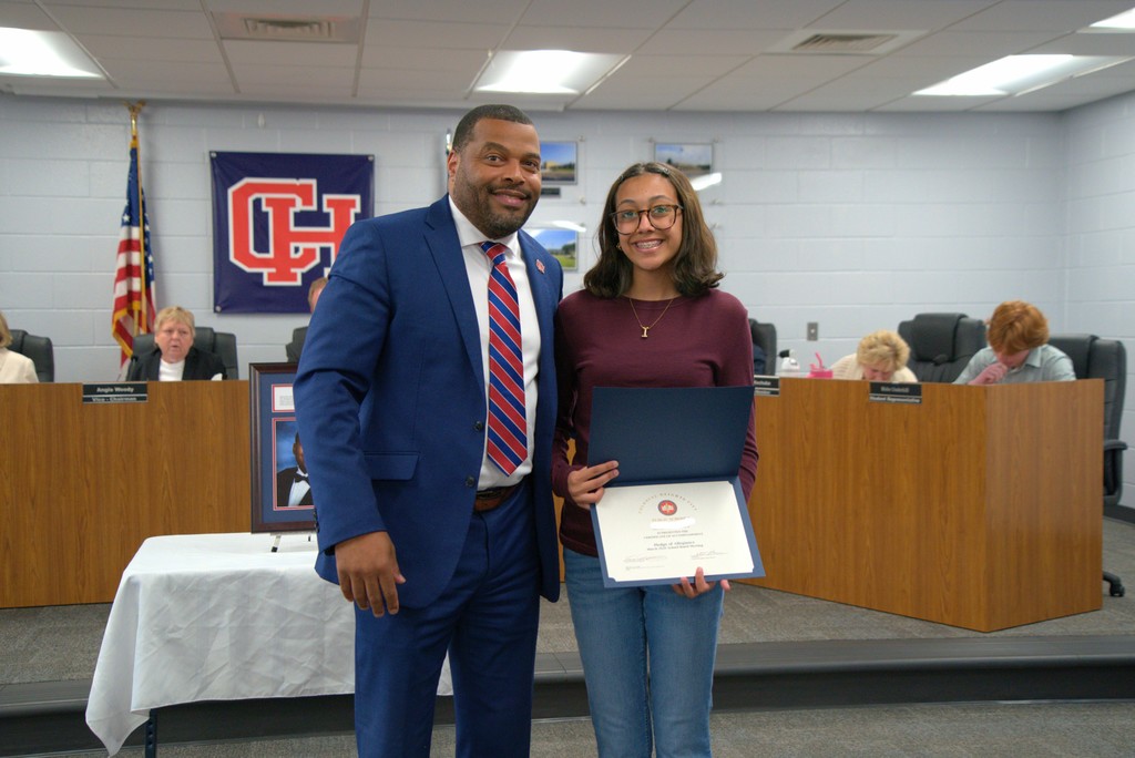 Superintendent with Student with Certificate of Achievement