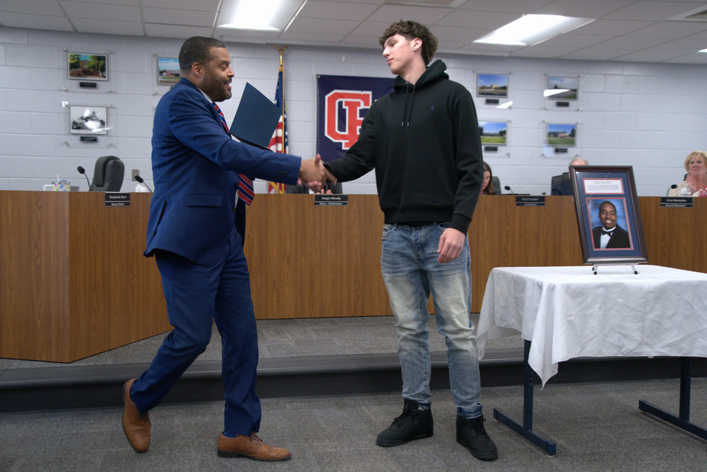 Superintendent Shaking Hands with Students