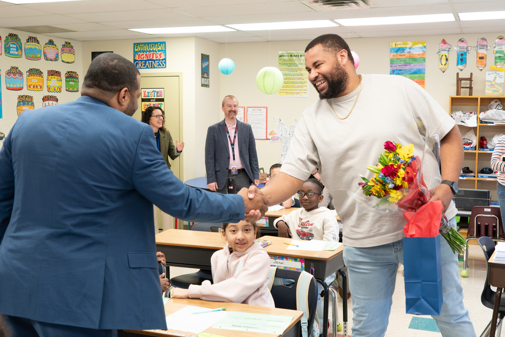 John Bonner, North Elementary Winner, shaking hands with Superintendent