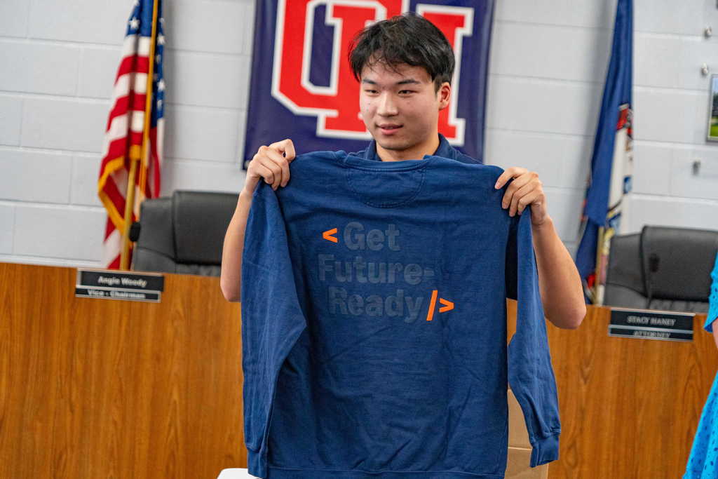 student holding "get future ready" t shirt