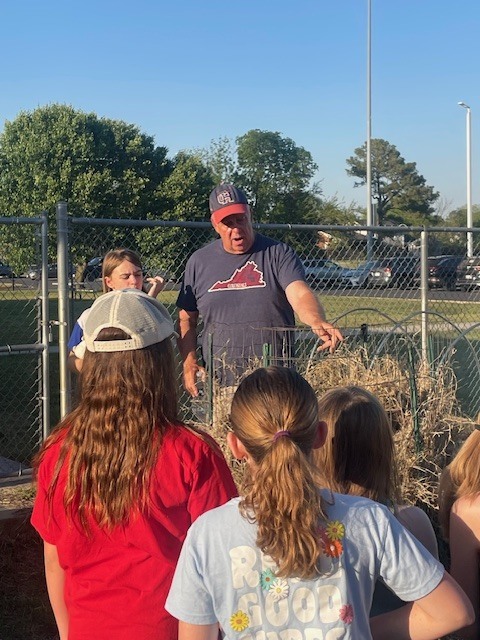 Bi o Teacher Showing Girl Scouts Plants