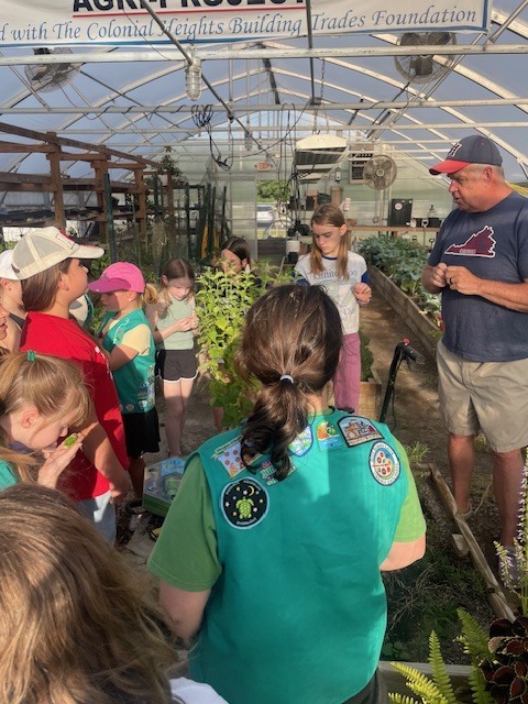 Bio Teacher Giving Girls Tour of Garden