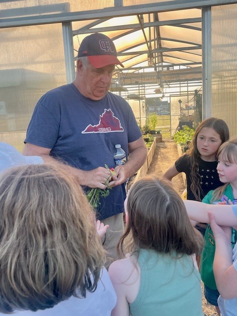 Bio Teacher Showing Girl Scouts Plants