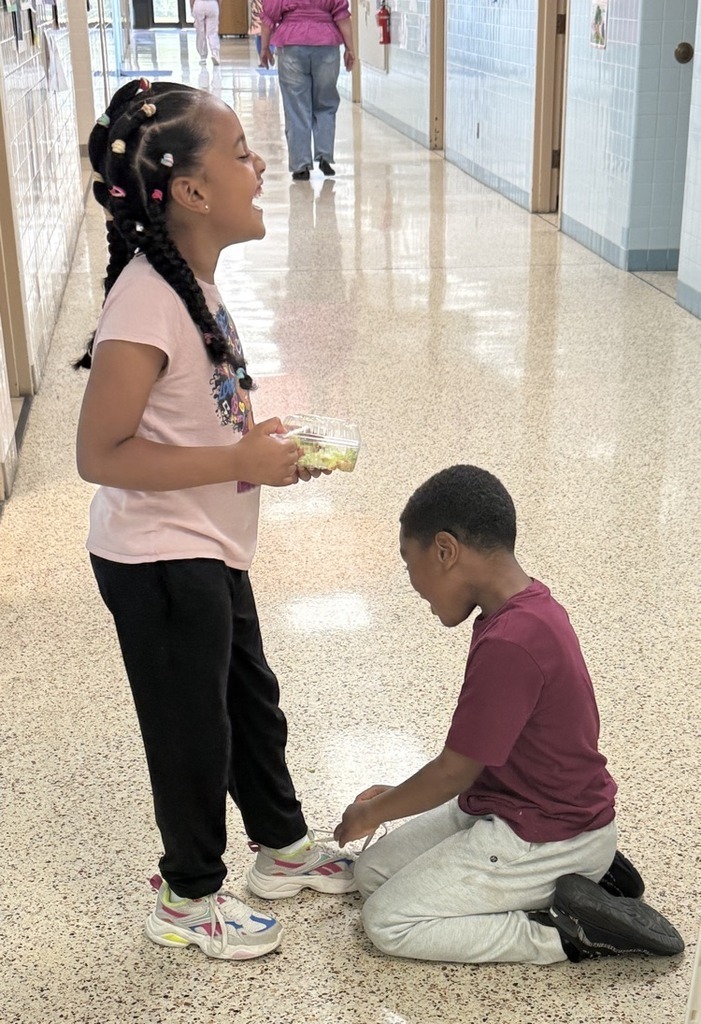 Boy helping Girl tie shoe