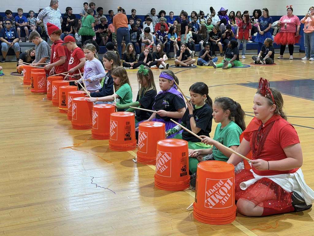 Elementary School Pep Rally, students playing bucket drums