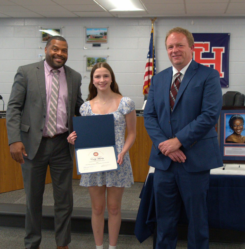 Award winning Swimmer with certificate, superintendent, and board chair