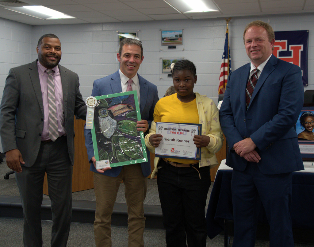 Award winning artist with superintendent, coordinator of fine arts, and board chair