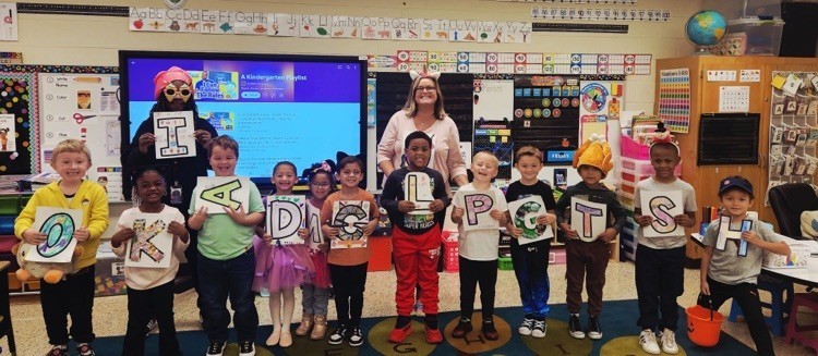 PreK Teacher with students with letters