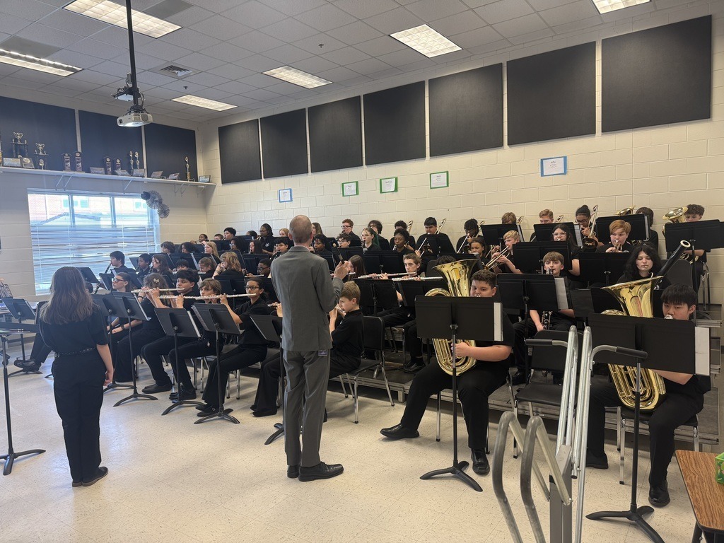 Band Teacher teaching band students with instruments