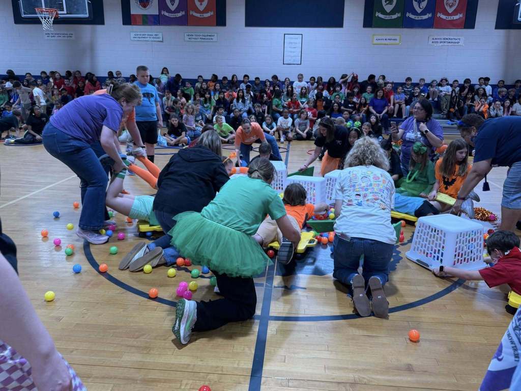 Teachers playing Hungry Hungry Hippos with Students
