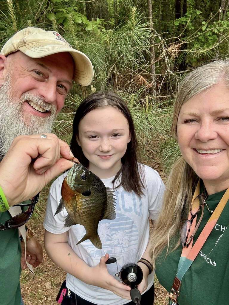 Middle School teachers with student catching fish
