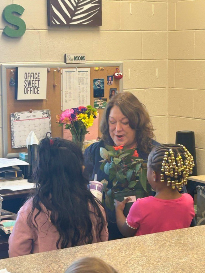 Girls Giving A Lady Flowers