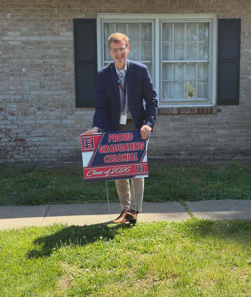 High School Principal Putting up Graduating Senior Sign