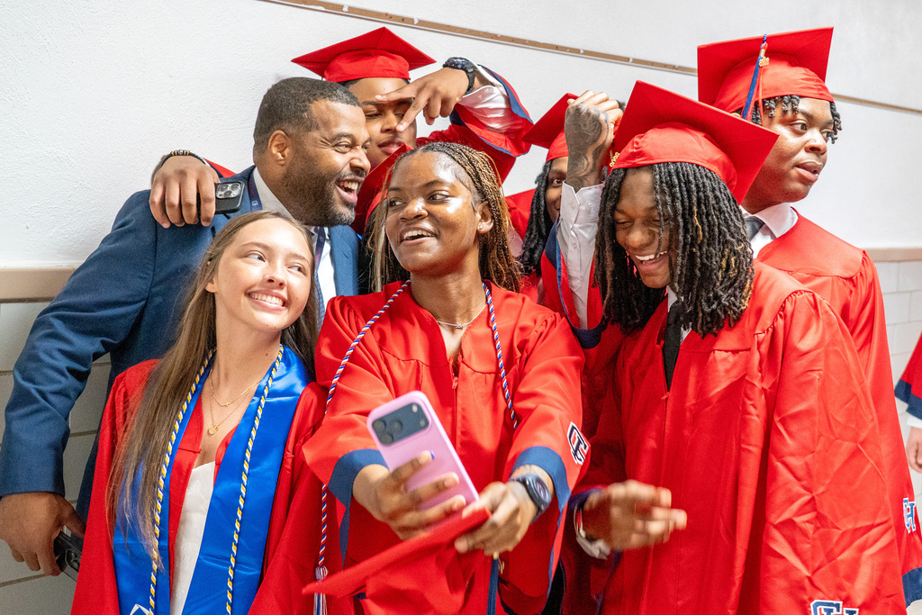 High School seniors taking selfie with superintendent