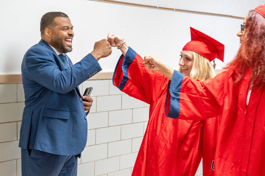 Students fist bumping superintendent