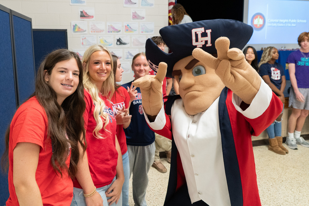 Seniors posting with Colonial Man