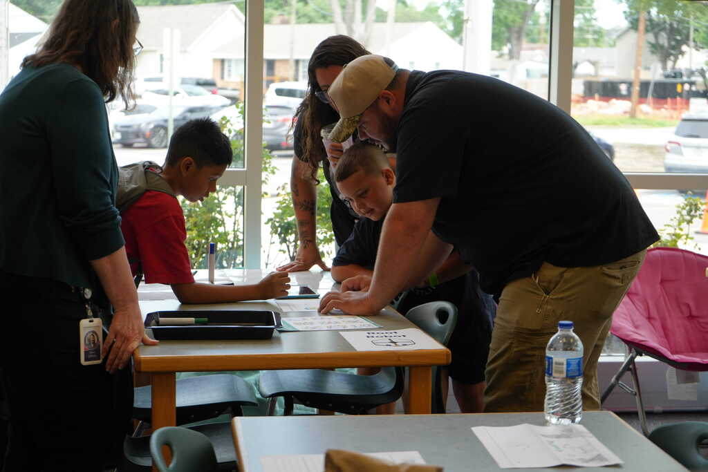 Boy Teaching Family on iPad