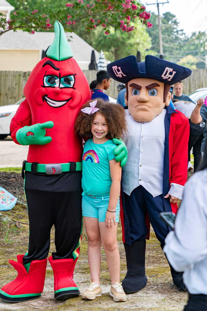 Chili Pepper and Colonial Man Mascot Posing with Student