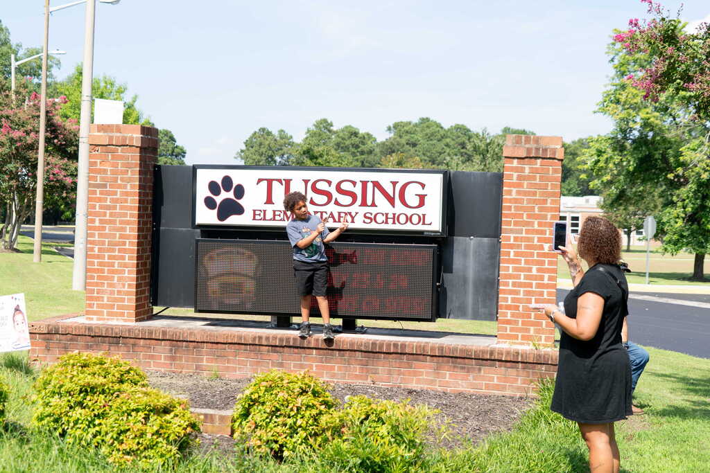 Student Posing with Tussing Elementary Marquee