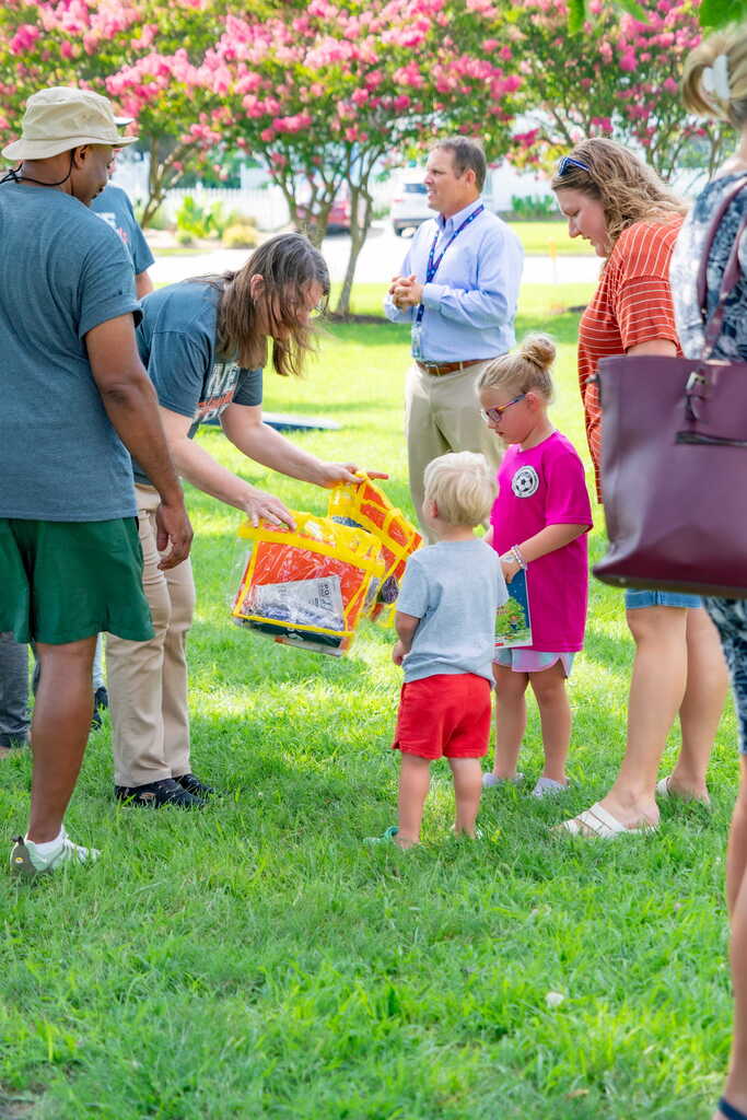 CHPS Teacher Handing Students Bag of Supplies