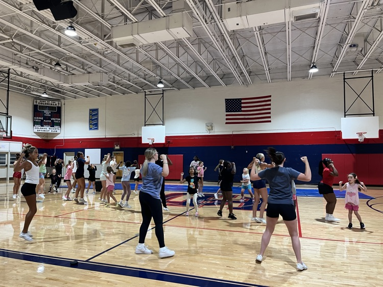 cheer camp picture with high school students helping elementary school students