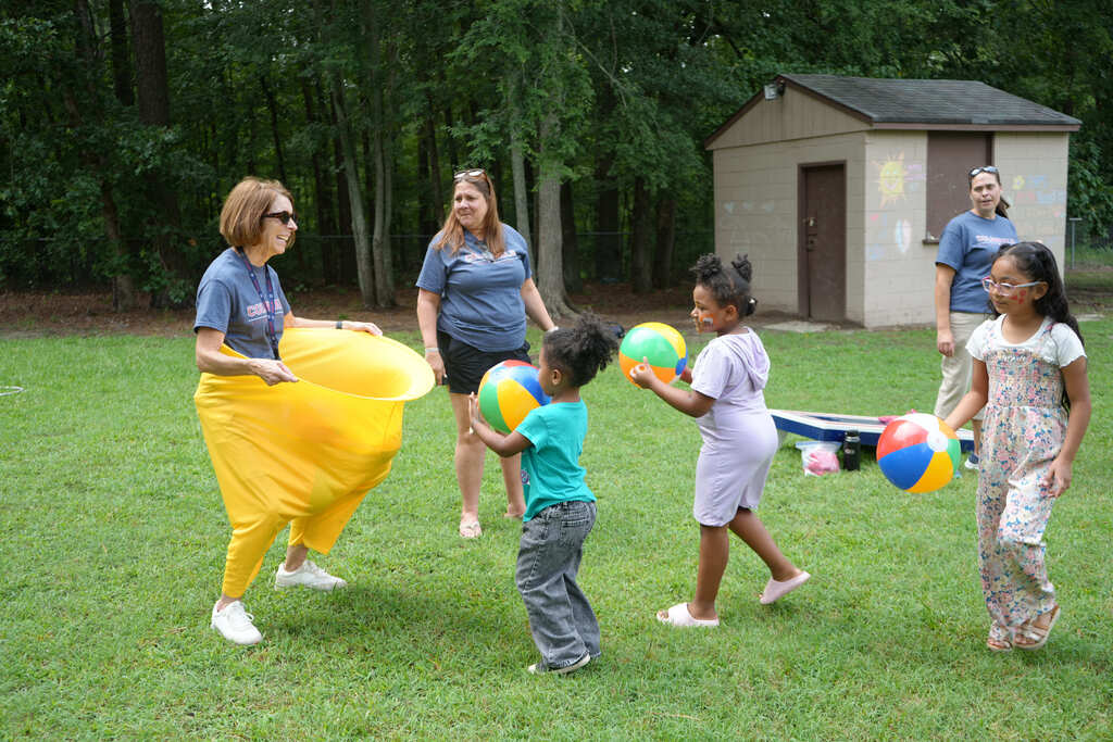Teacher Playing Ball with Students