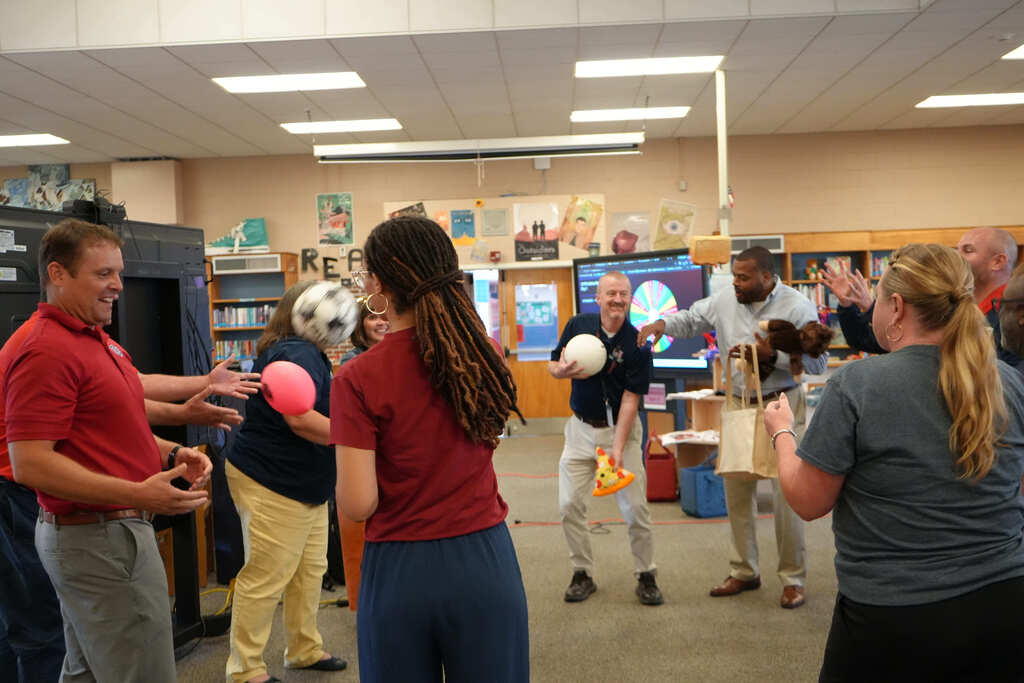 Leaders Playing Game and Tossing Balls